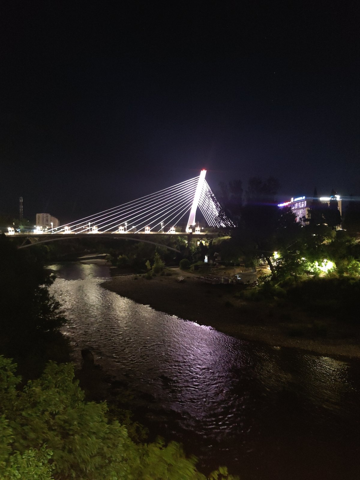 Podgorica's Millennium Bridge glowing after dark