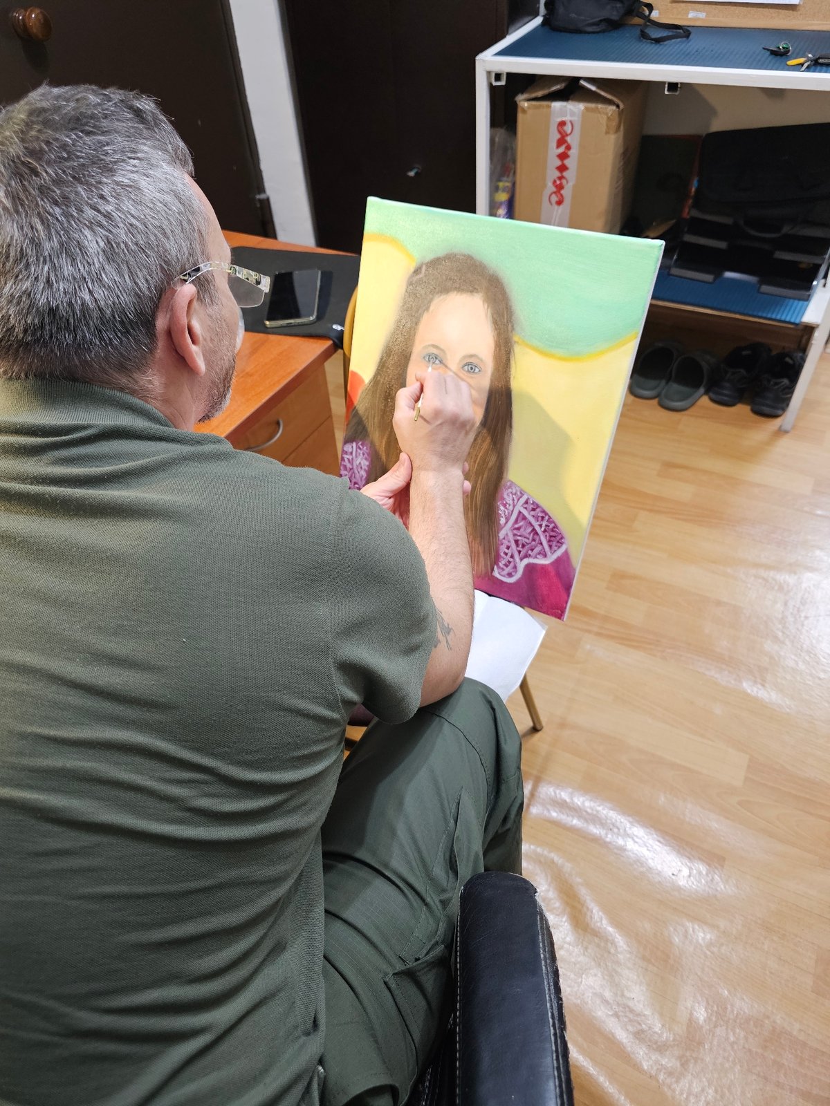 Artist paints woman's portrait in Moscow studio session