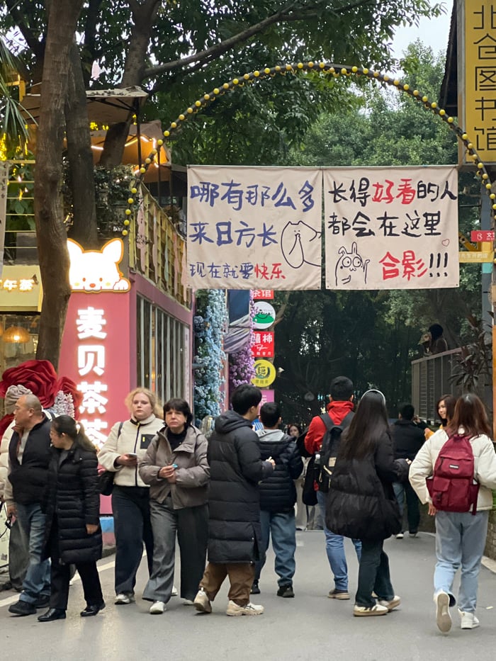 Daily life unfolds across Liangjiang commercial districts under overcast skies