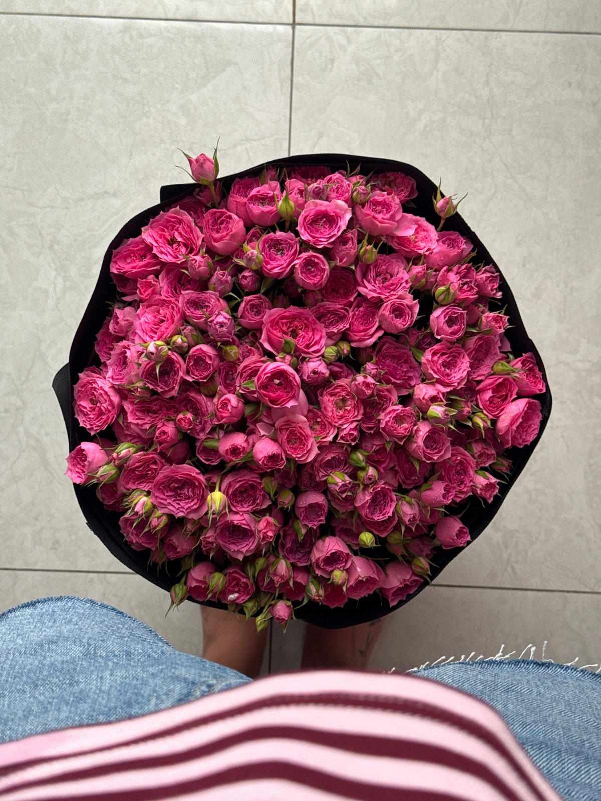 Pink rose bouquet in black wrap, overhead view, Nha Trang