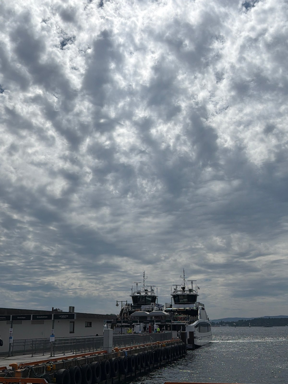 Cloudy morning at Aker Brygge — ferries, streets, and Oslo life