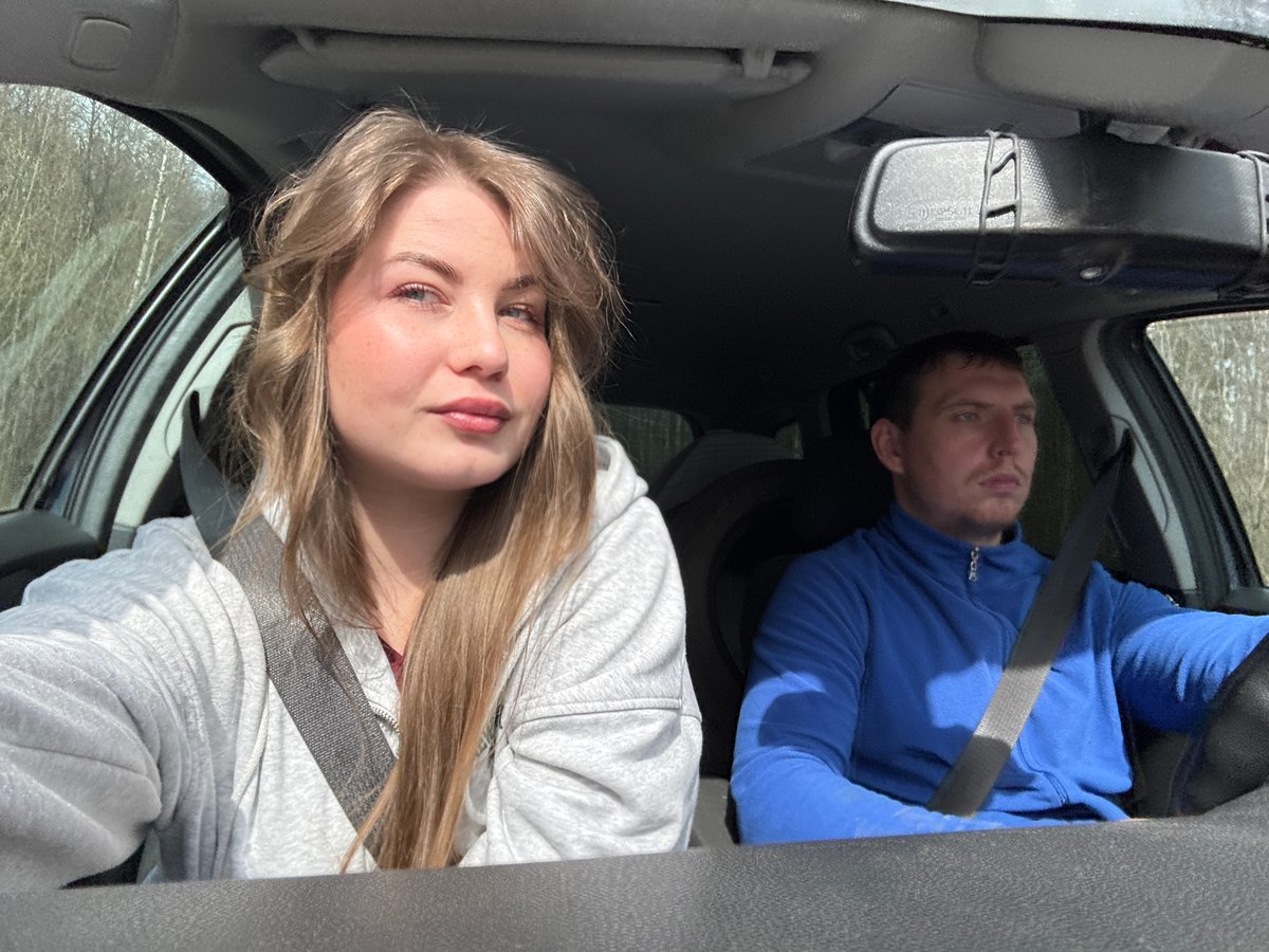 Young woman photographed as passenger in vehicle, Russia