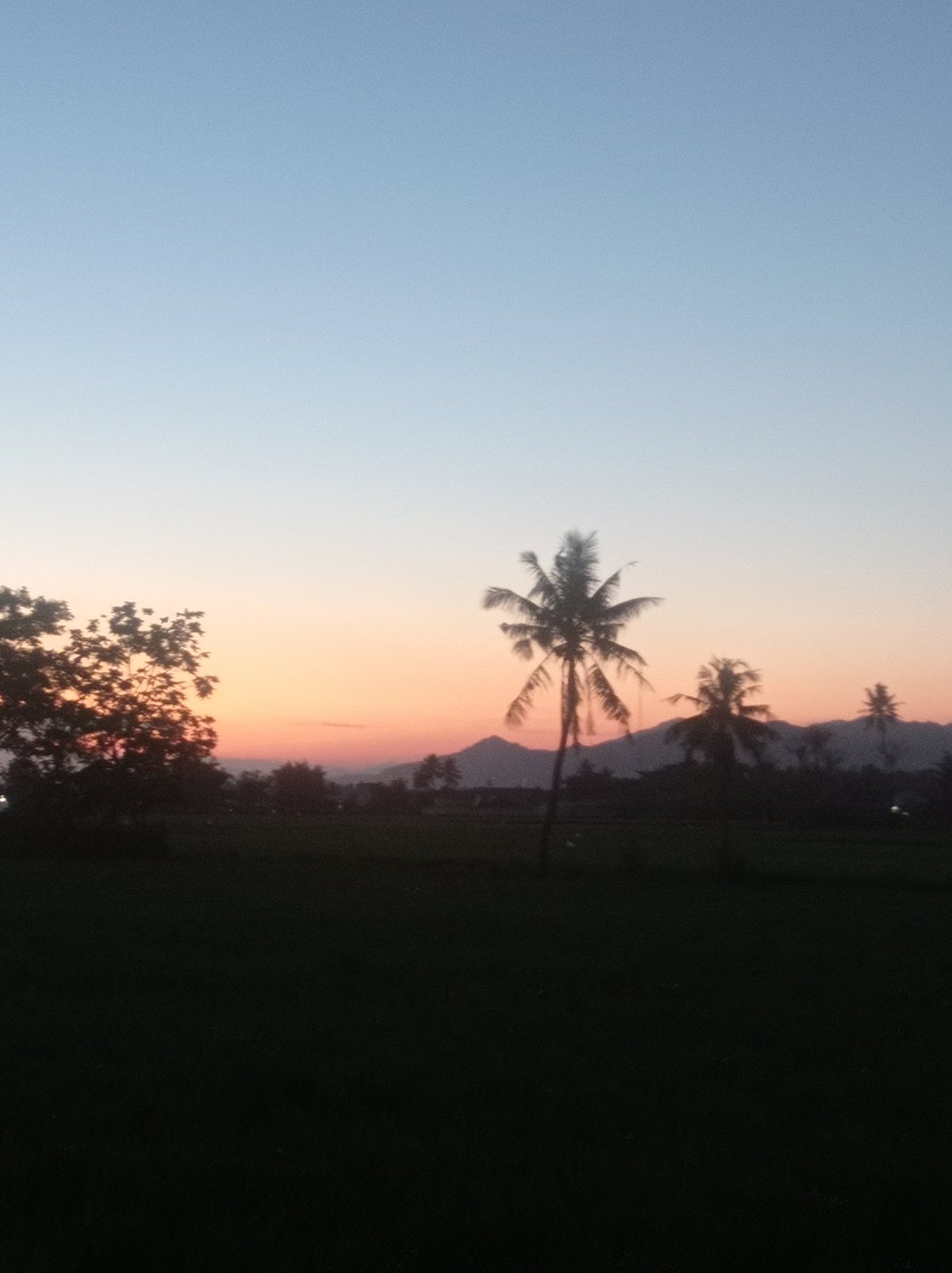 Dusk settles over rural Desa Toto Selatan, Indonesia
