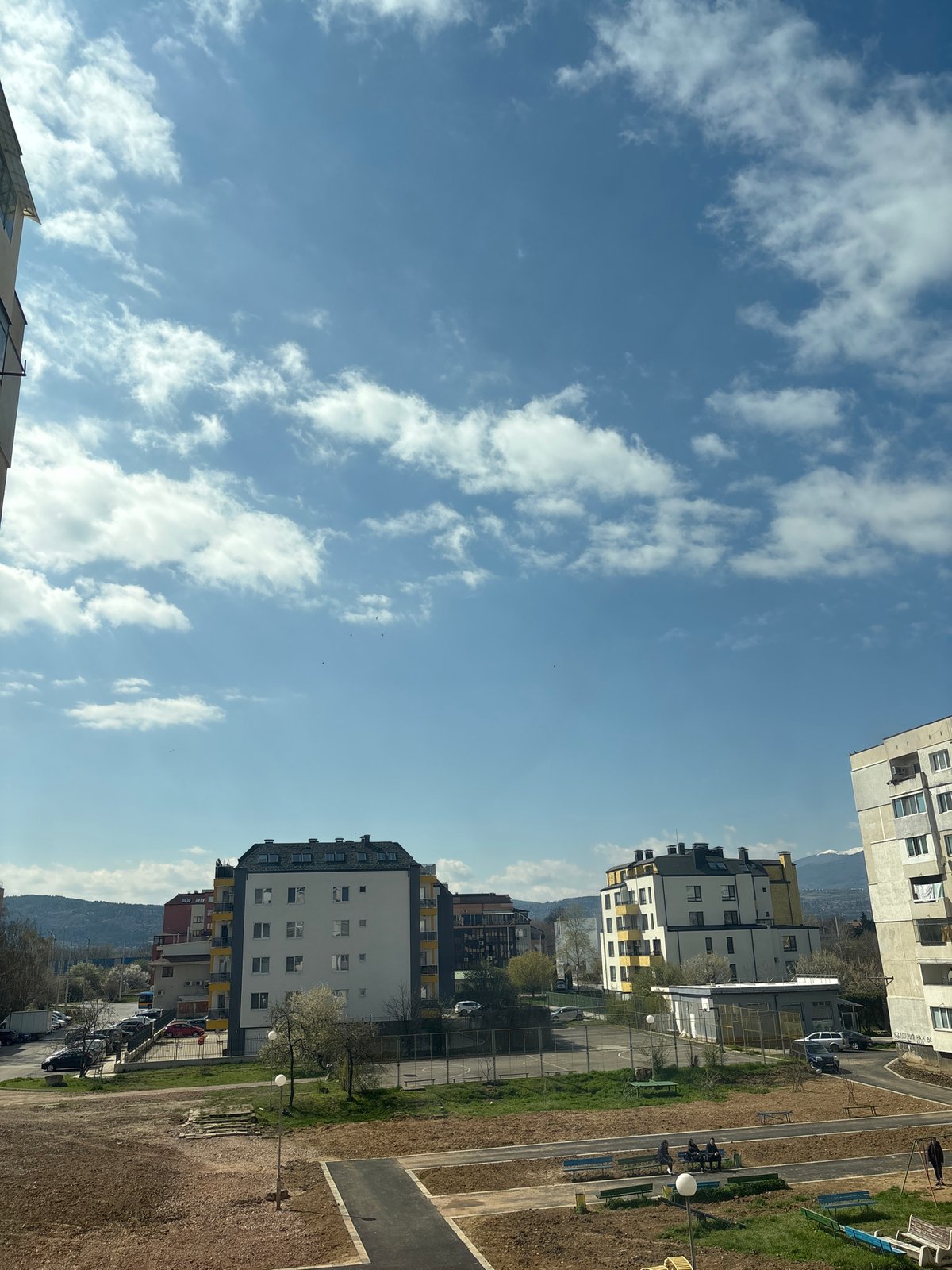 Sofia cityscape observed under bright partly cloudy morning sky