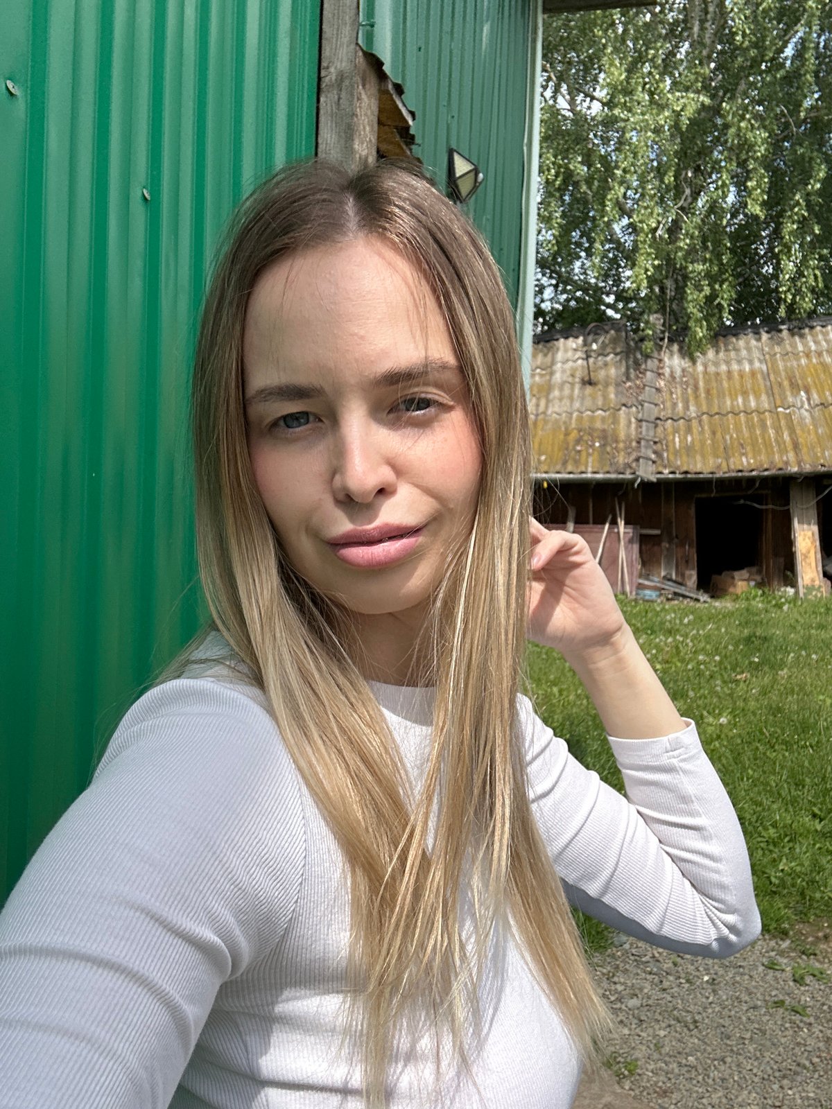 Woman plays with dog during sunny morning in rural Russia