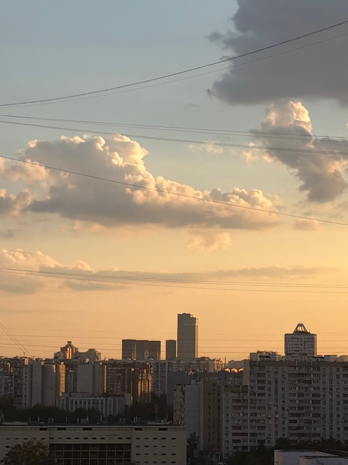 Moscow residential neighborhoods glow under a late-afternoon sunset.