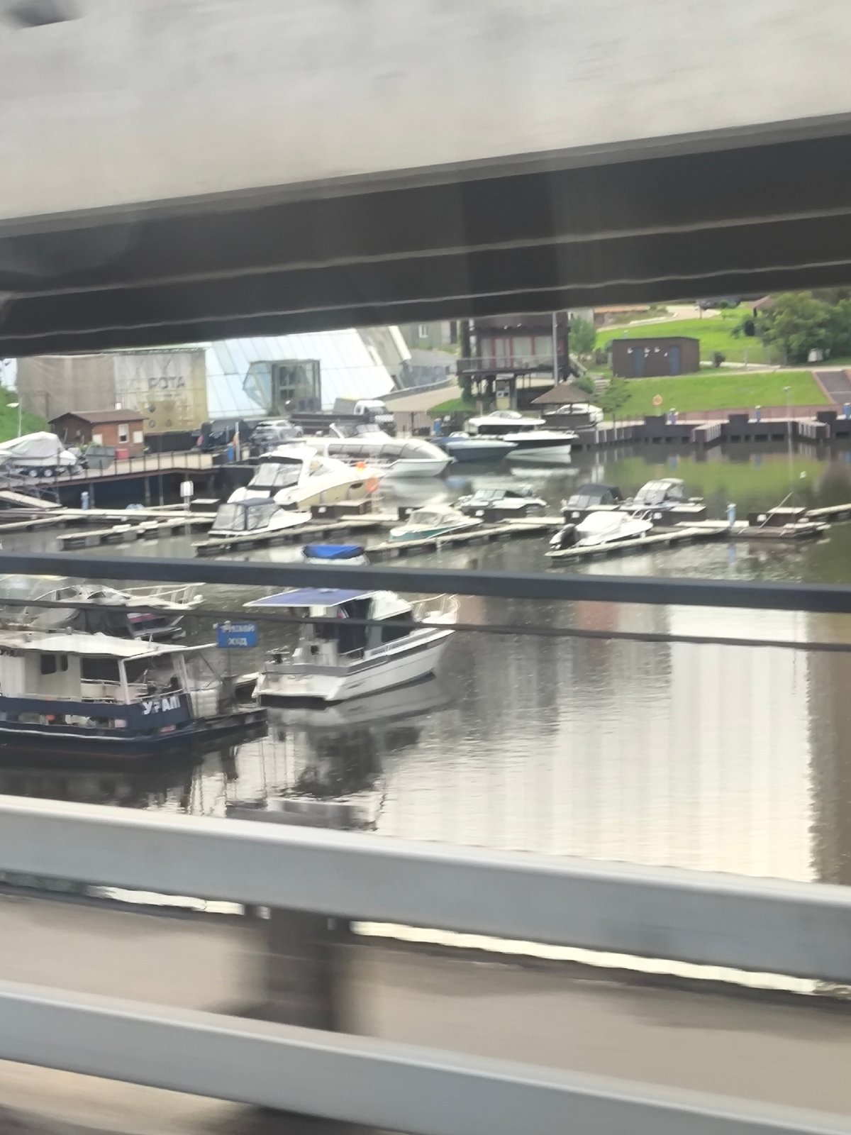 Woman photographed at waterfront marina under overcast skies