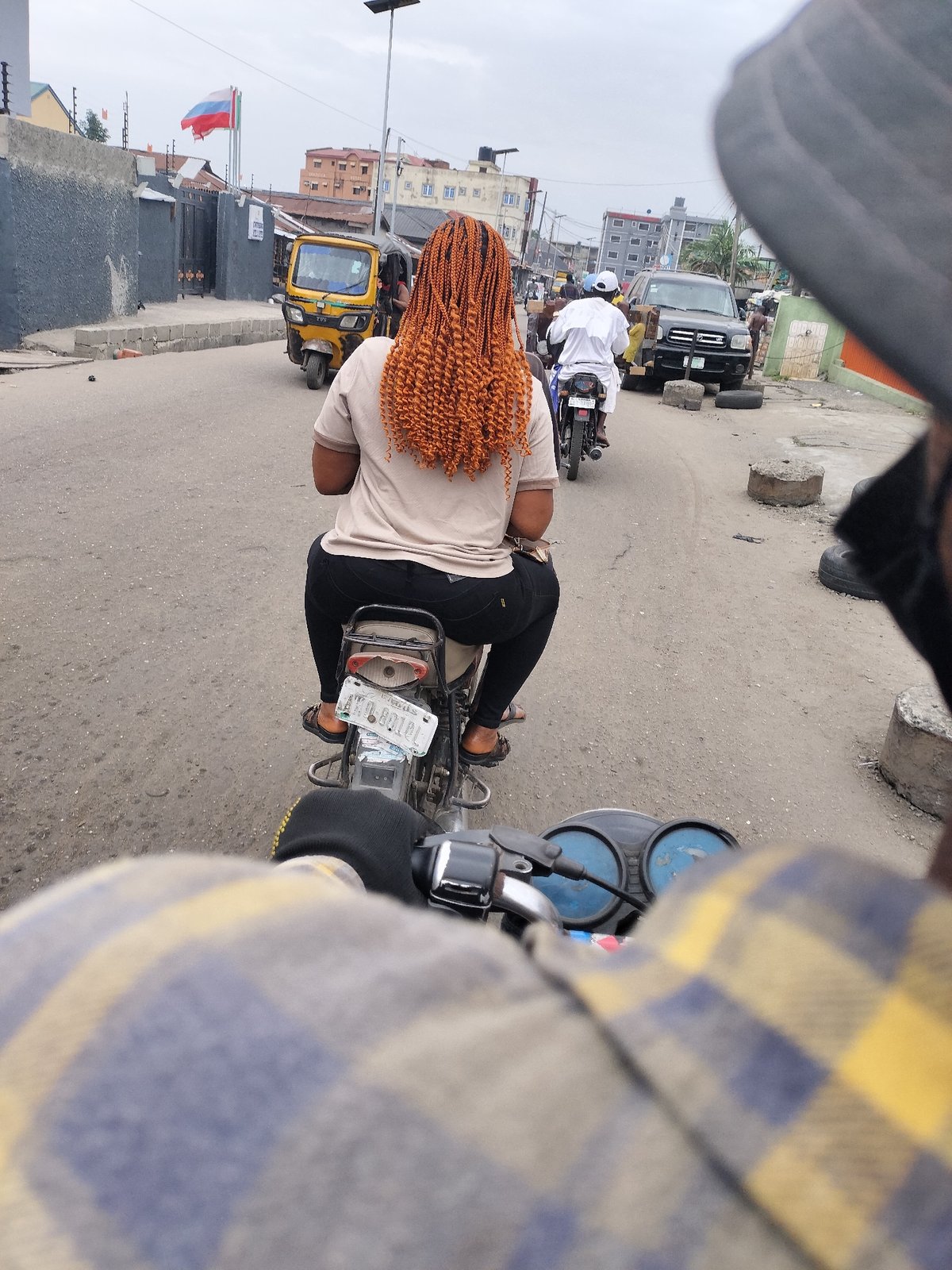 Street activity observed in Alaiyabiagba featuring motorcycle passenger, van