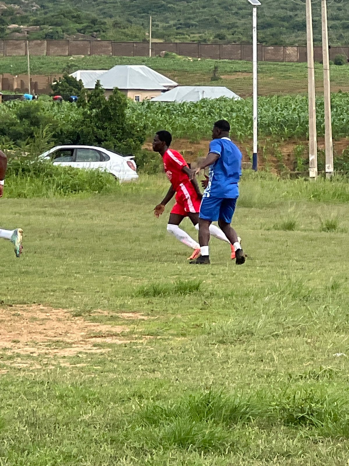 Soccer practice and match play on a field in Jos, Nigeria