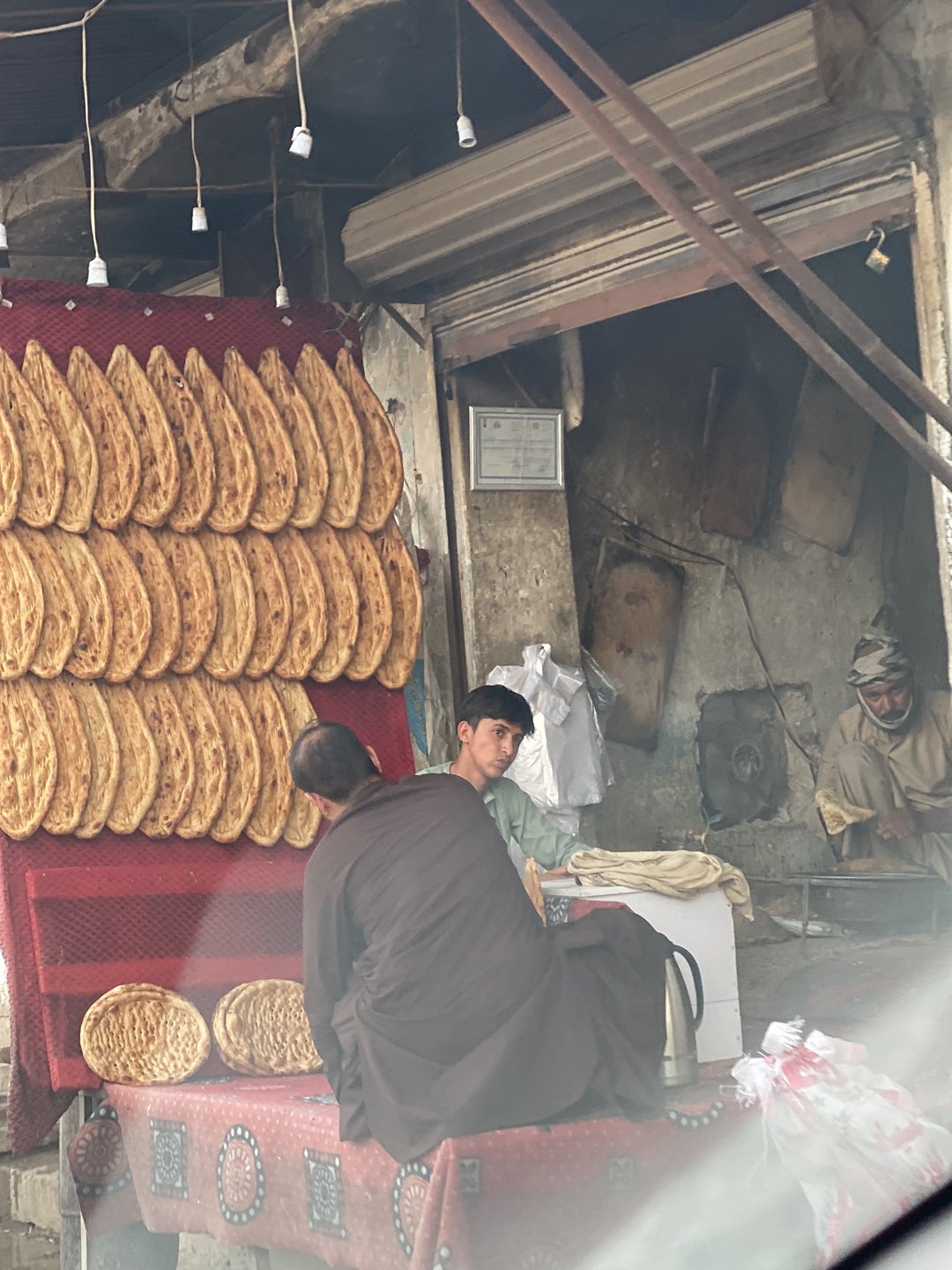 Daily street life captured in hazy Kandahar afternoon