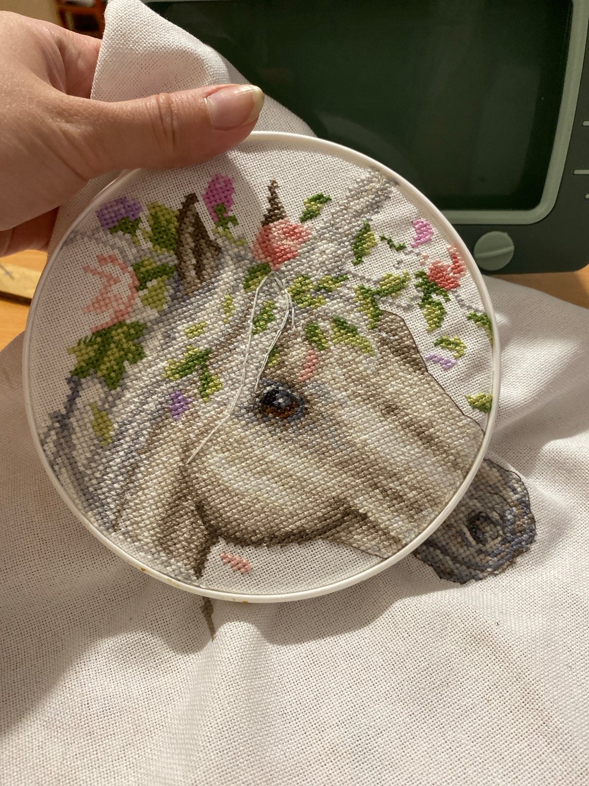 Cross-stitch crafting session documented during Yekaterinburg sunset