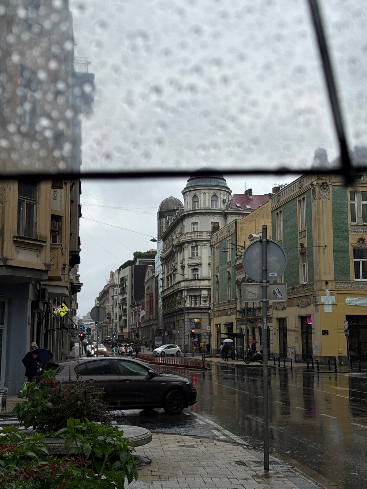Rainy afternoon scenes documented across Belgrade streets and neighborhoods