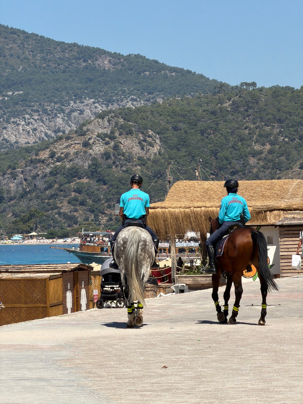 Morning beach life and mounted police patrols in Fethiye