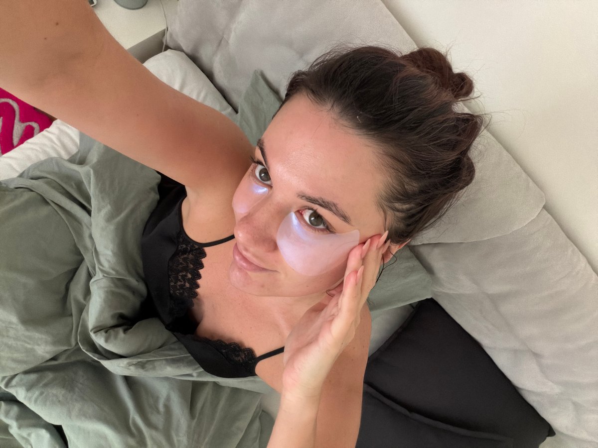 Woman rests in bed with eye mask in Belgrade