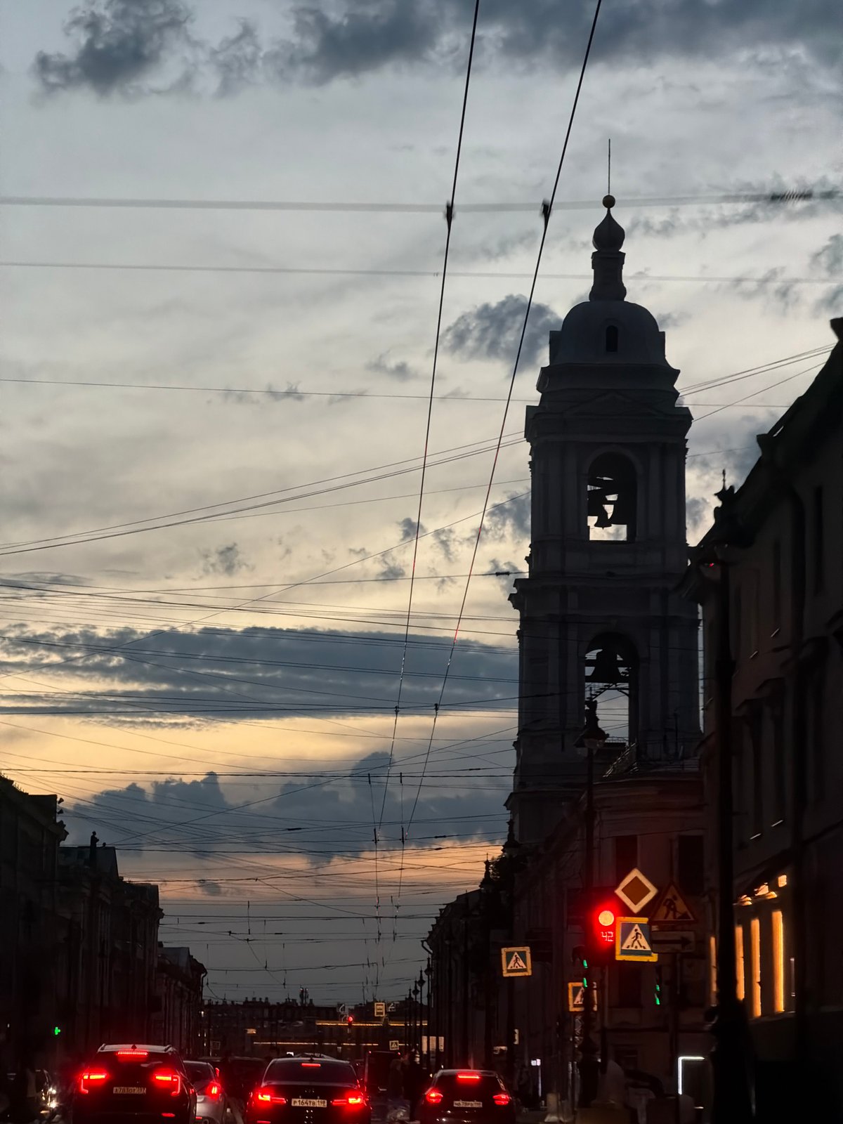 Dusk street scene photographed in Saint Petersburg showing bell tower