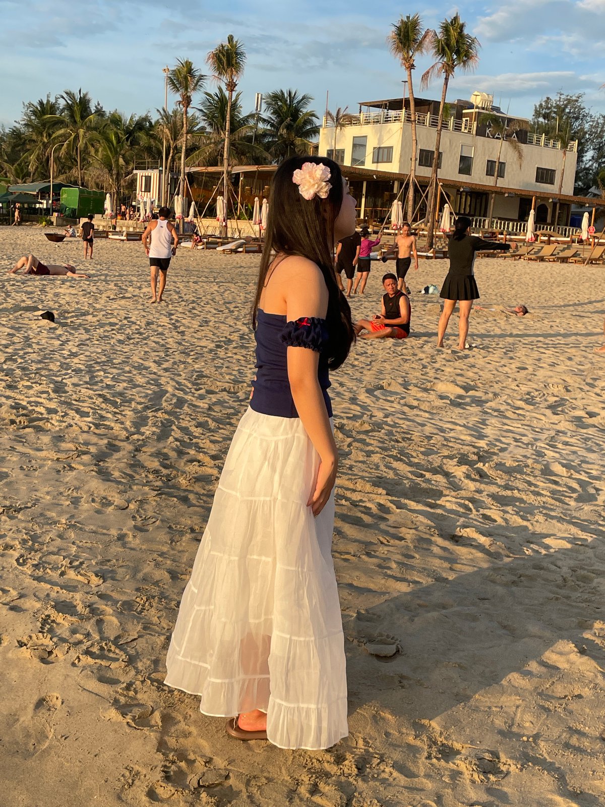Busy evening at My Khe Beach and Da Nang streets at dusk