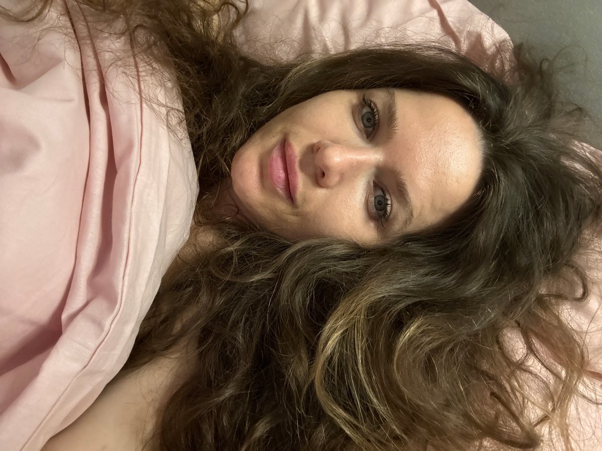 Woman photographed in bed in Moscow evening hours