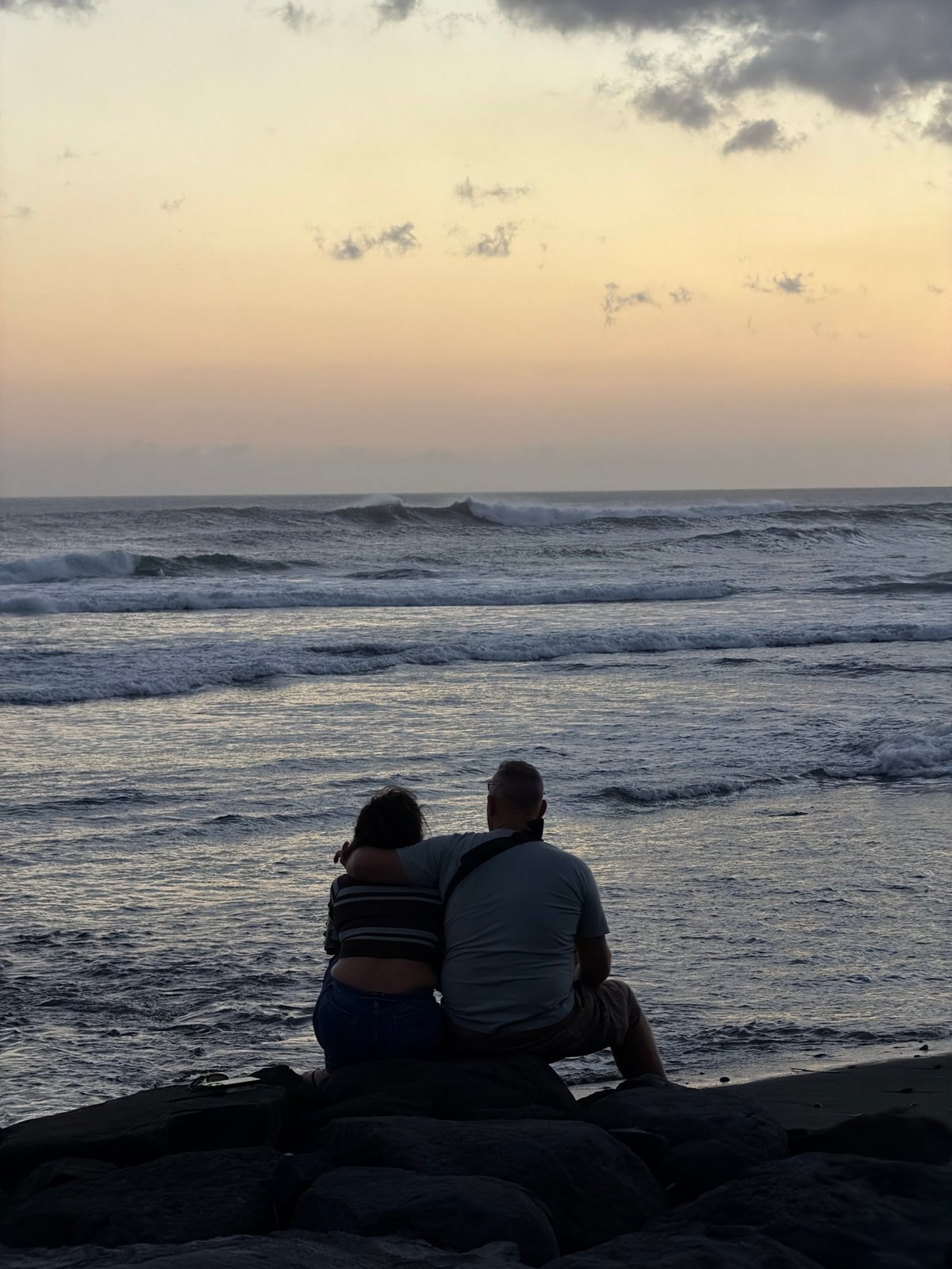 Sitting oceanside on the rocks at Echo Beach, Canggu