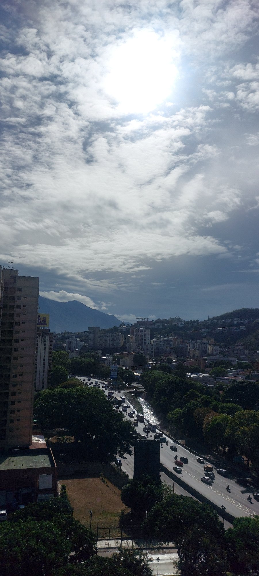 Daylight panoramic views captured of Caracas cityscape under bright skies