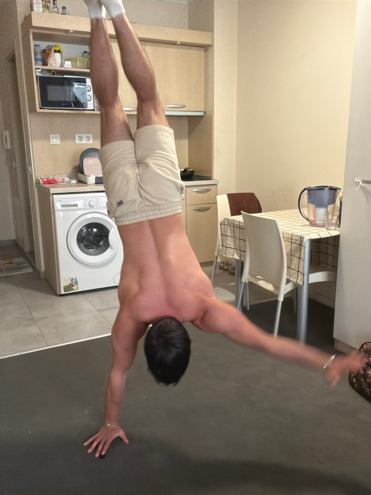 Man performs indoor calisthenics workout in Sofia breakroom