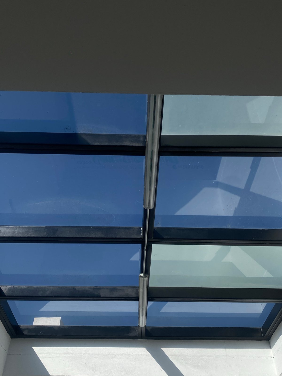 Building windows reflect clear blue sky in architectural photograph