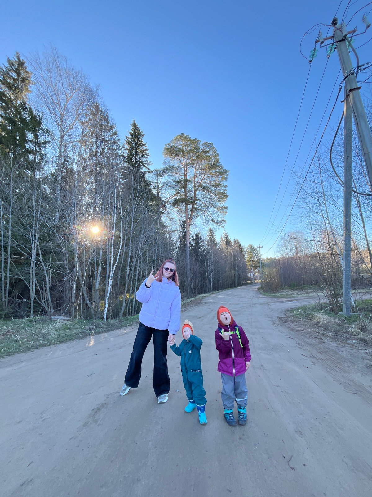 Family photographed on dirt road in Chaikovsky, Russia