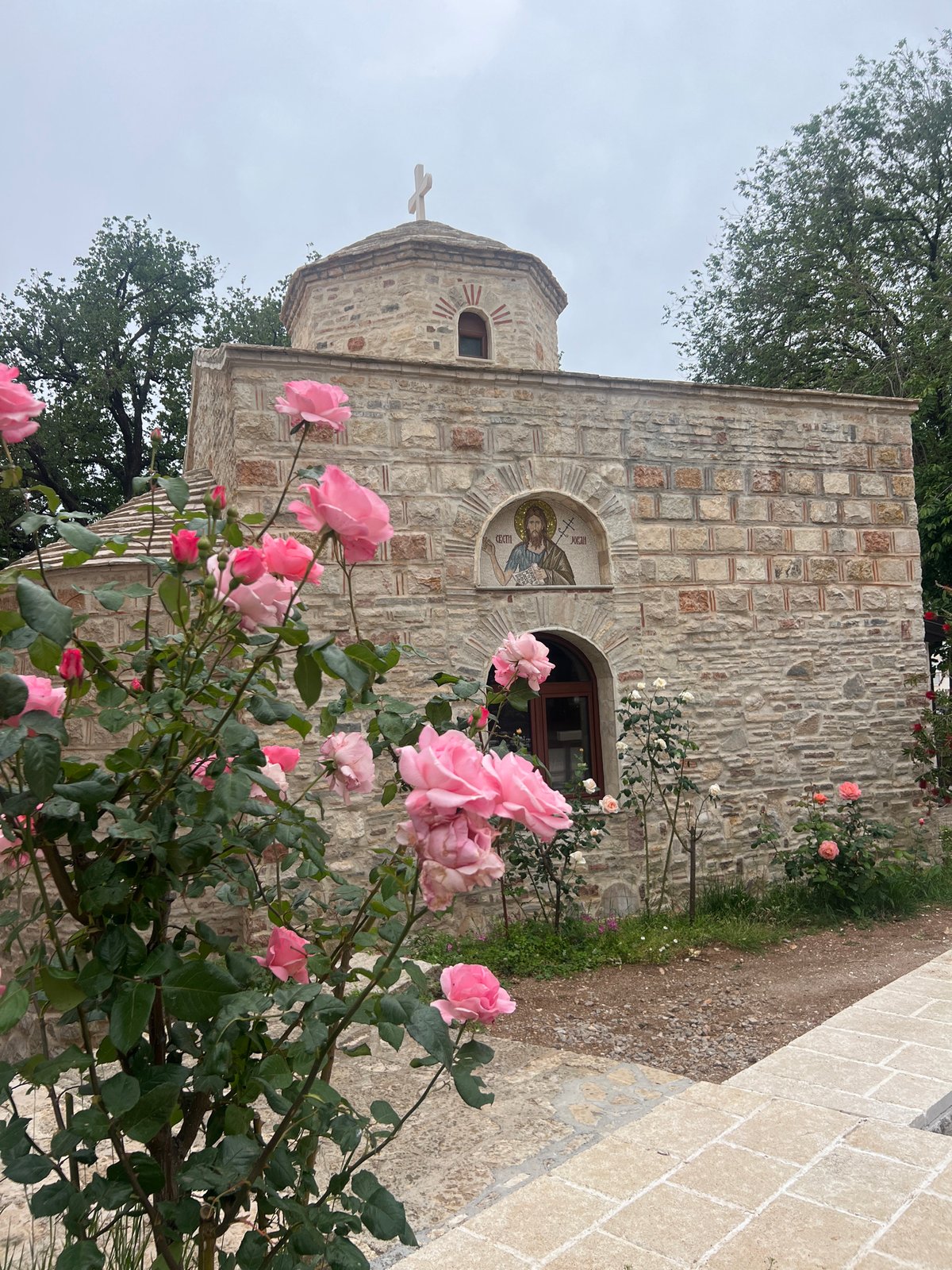 Stone church with rose garden documented in Budva, Montenegro