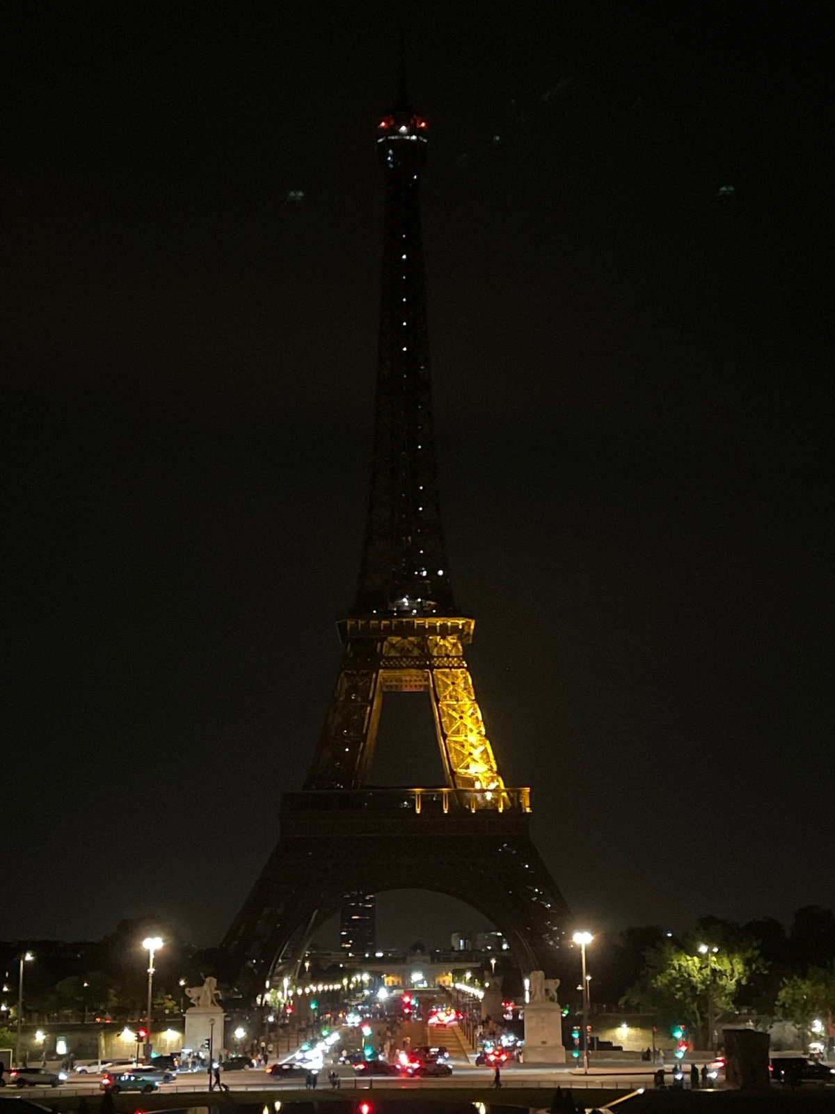 Eiffel Tower glows golden in Paris night scene