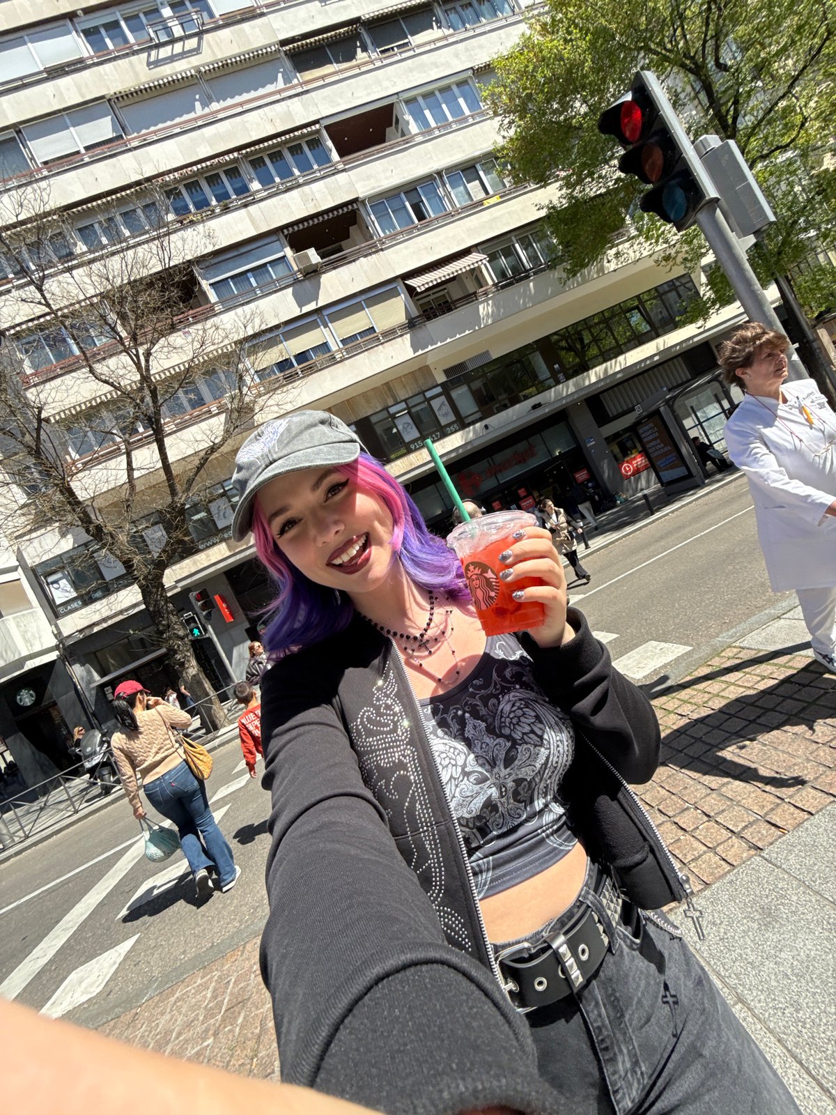Woman with colorful hair takes selfies across Madrid locations