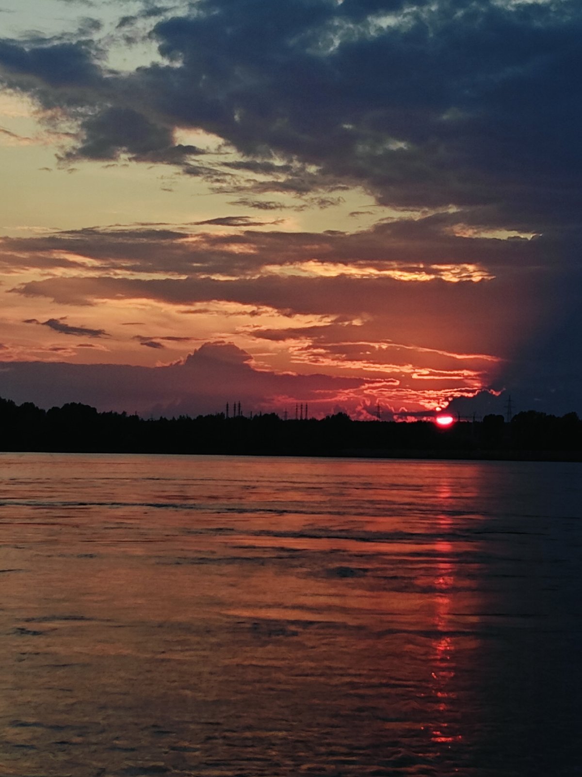Evening fishing session on Kama River during dramatic sunset