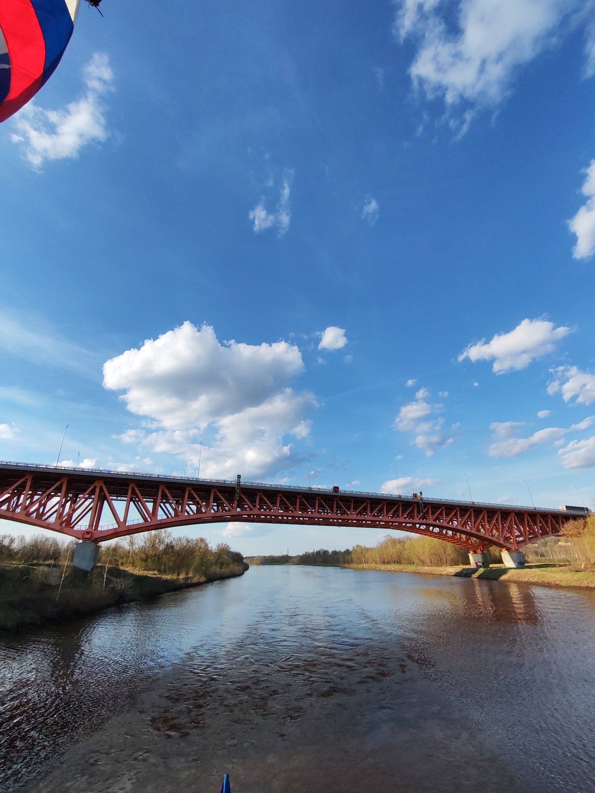 Barge approaches orange bridge on Volga River near Ples