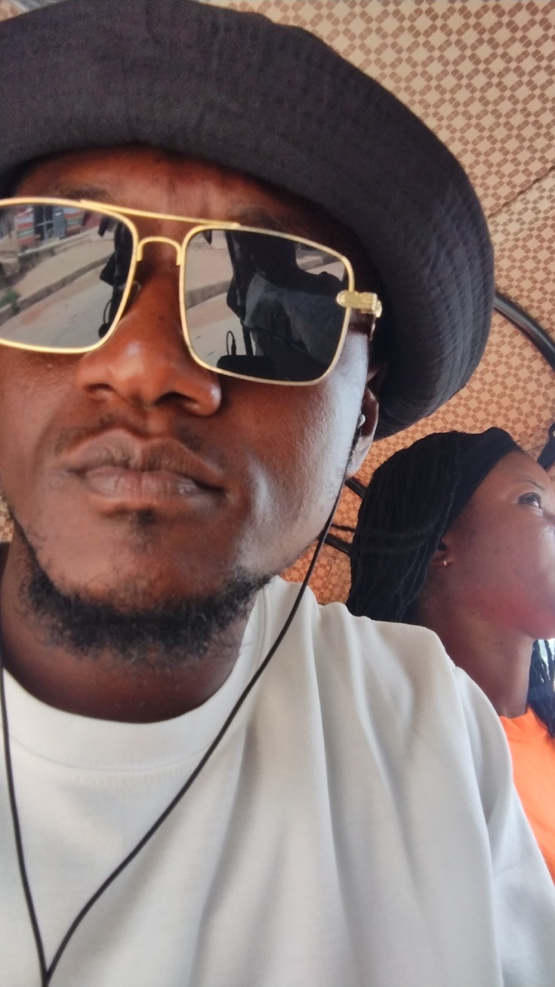 Person rests outdoors in Jos as storm clouds gather