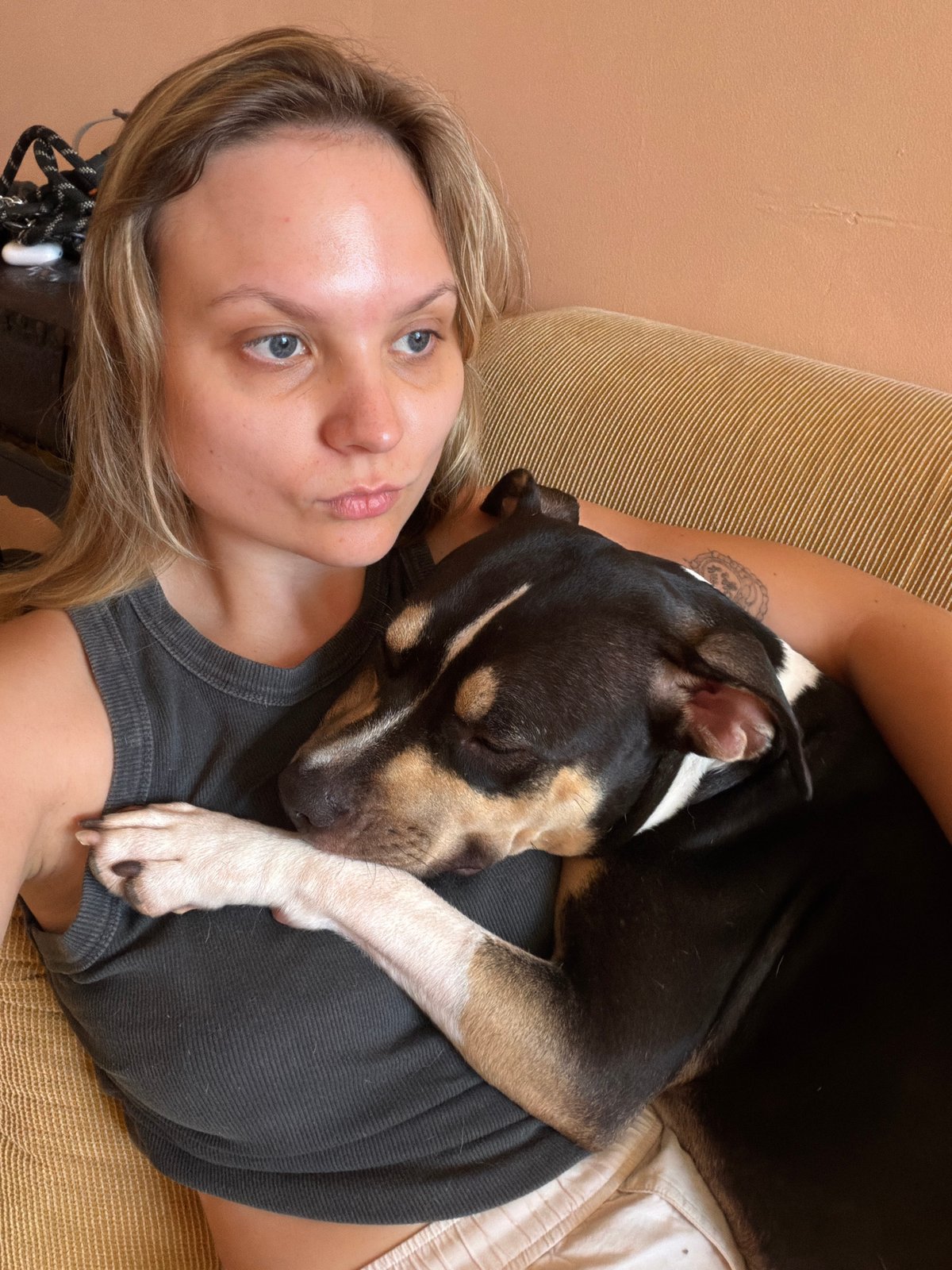 Woman and dog share quiet moment on Tel Aviv couch