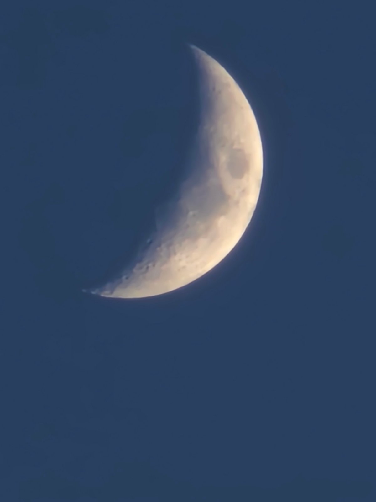 Crescent moon observed in evening sky over Kalinovka, Russia