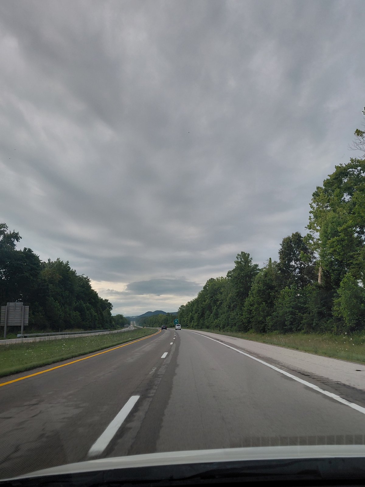 Driving through a tree-lined two-lane highway in Clay City