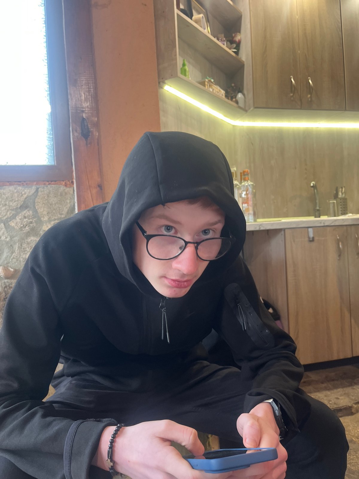 Person with phone captured indoors in Bulgarian residence