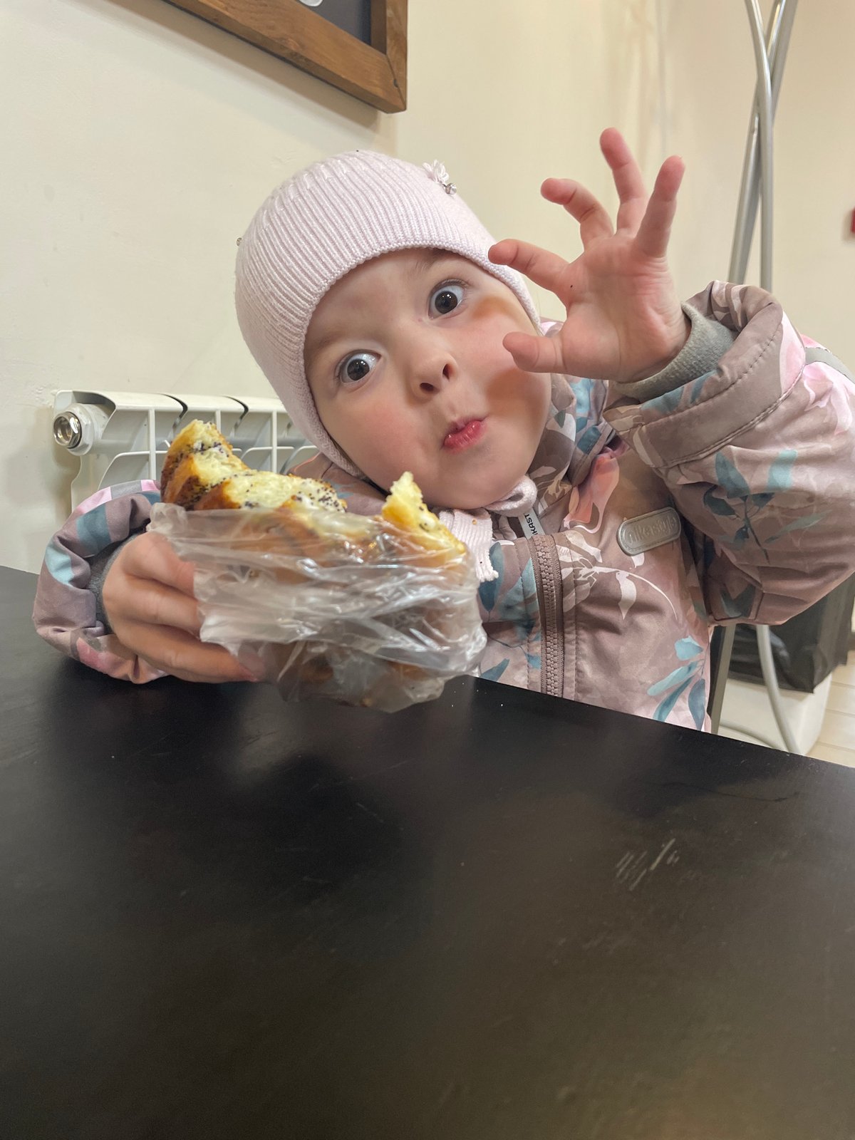 Child with pastry spotted in winter clothing in Chaikovsky