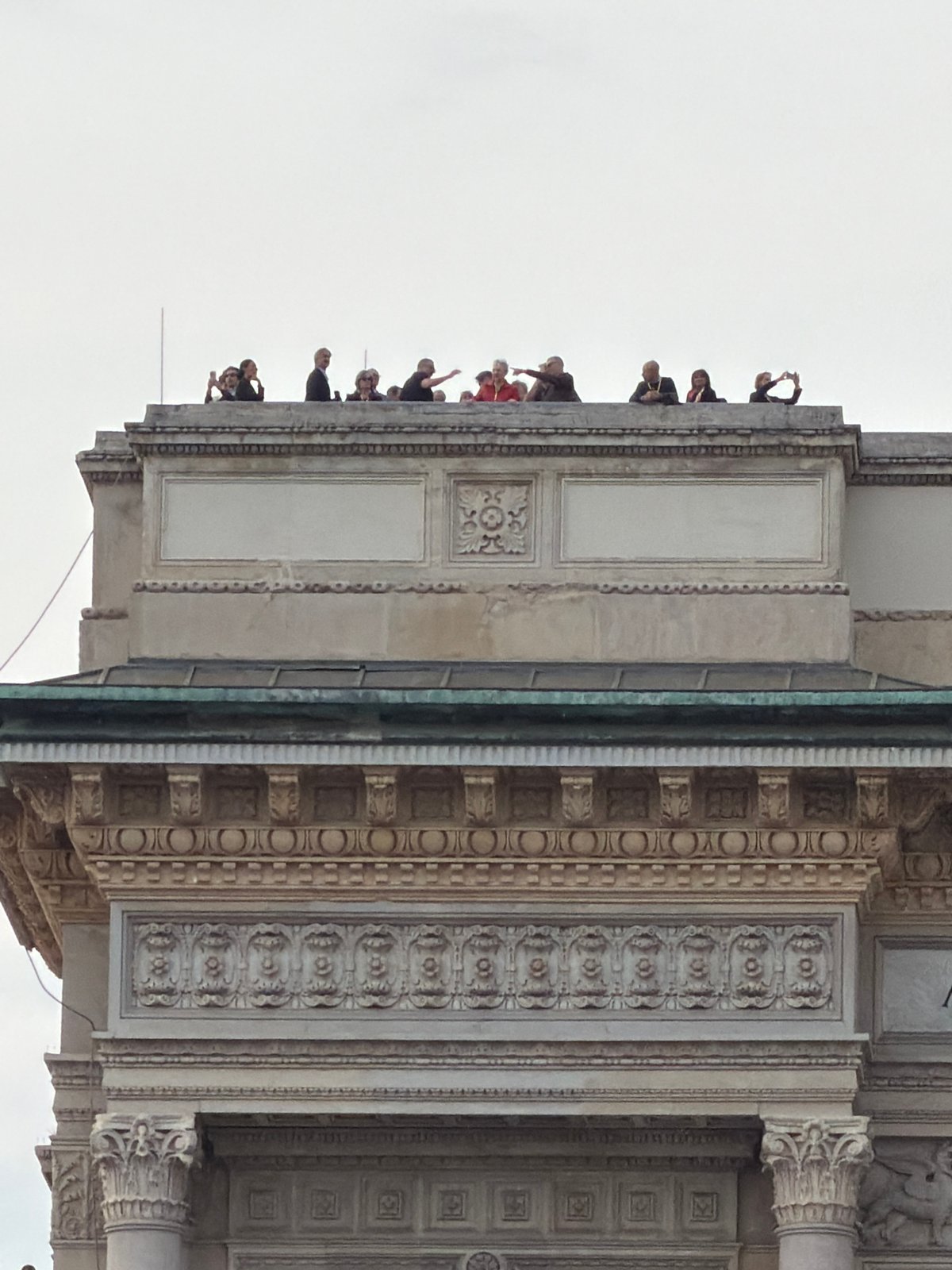Tourist documents Milan's historic architecture during afternoon visit