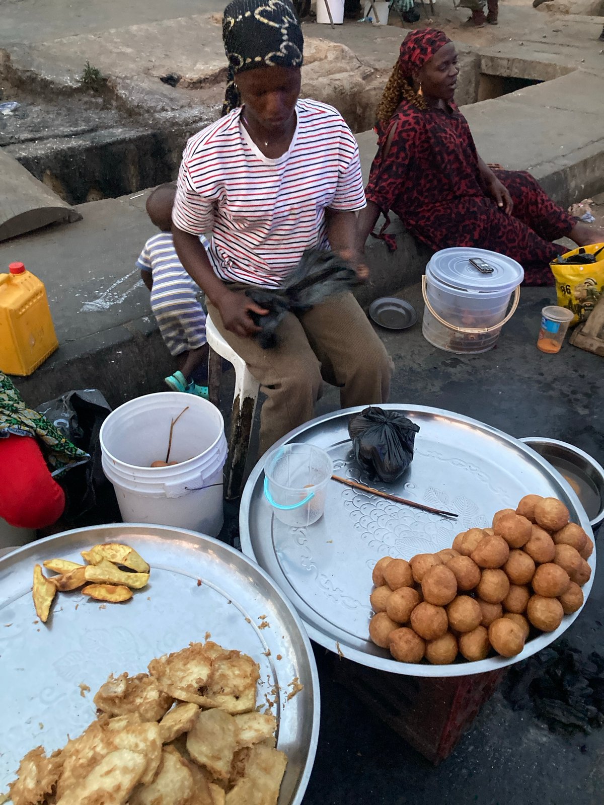 Women sell traditional street food in Jos, Nigeria