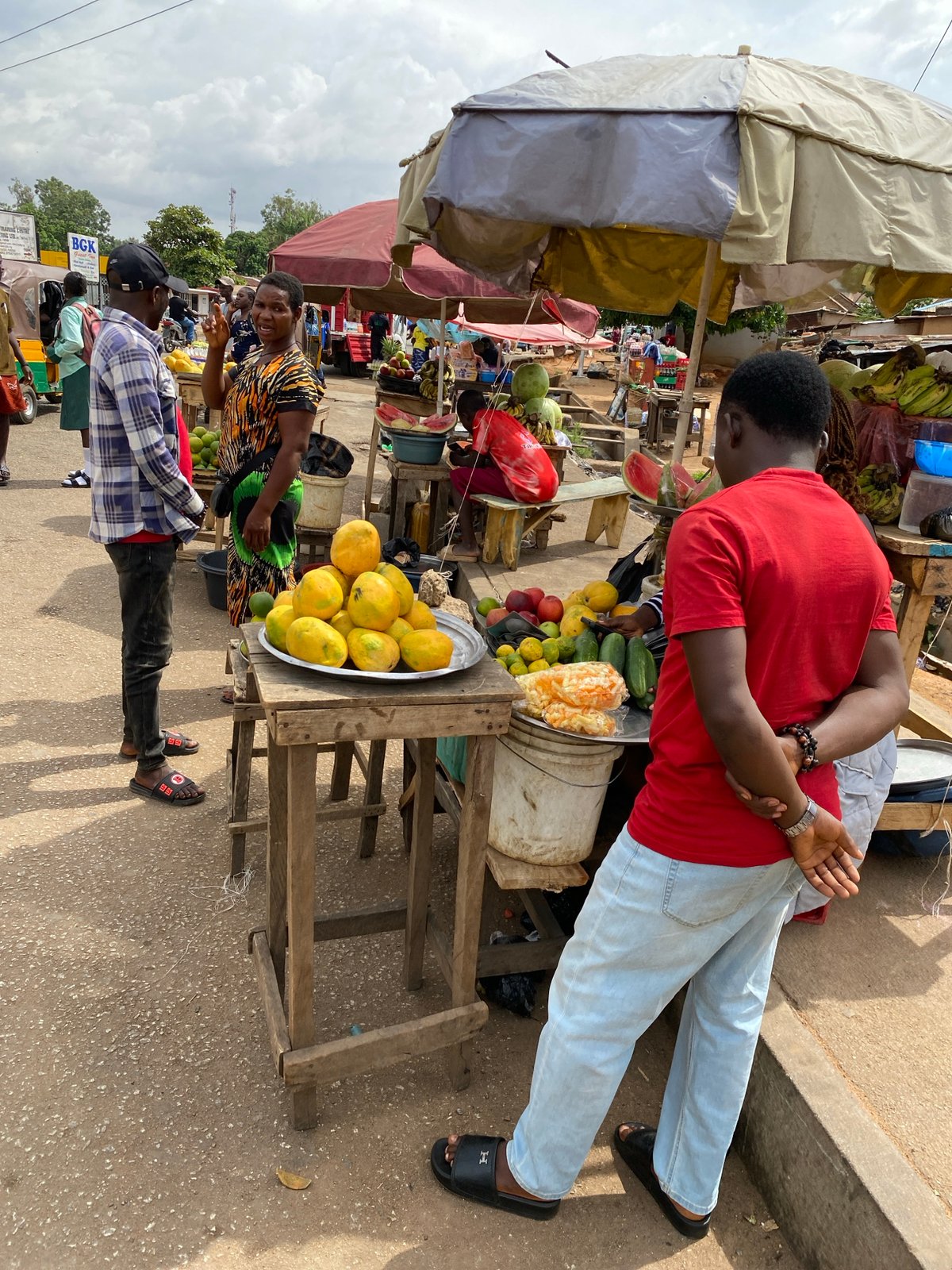 Outdoor market vendors sell produce in Bukuru, Nigeria