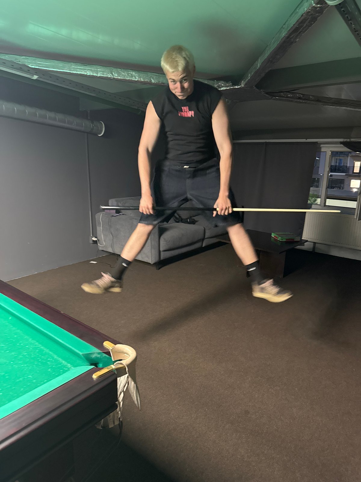 Friends enjoy casual pool game session with selfies
