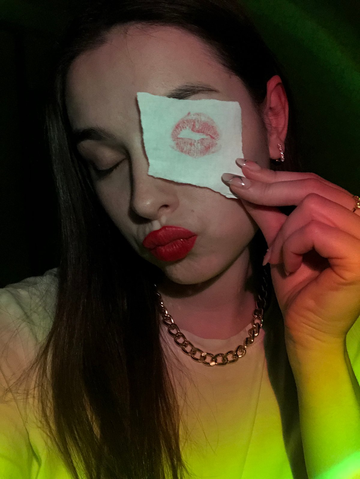 Woman photographed with lipstick kiss paper over eye in Russia