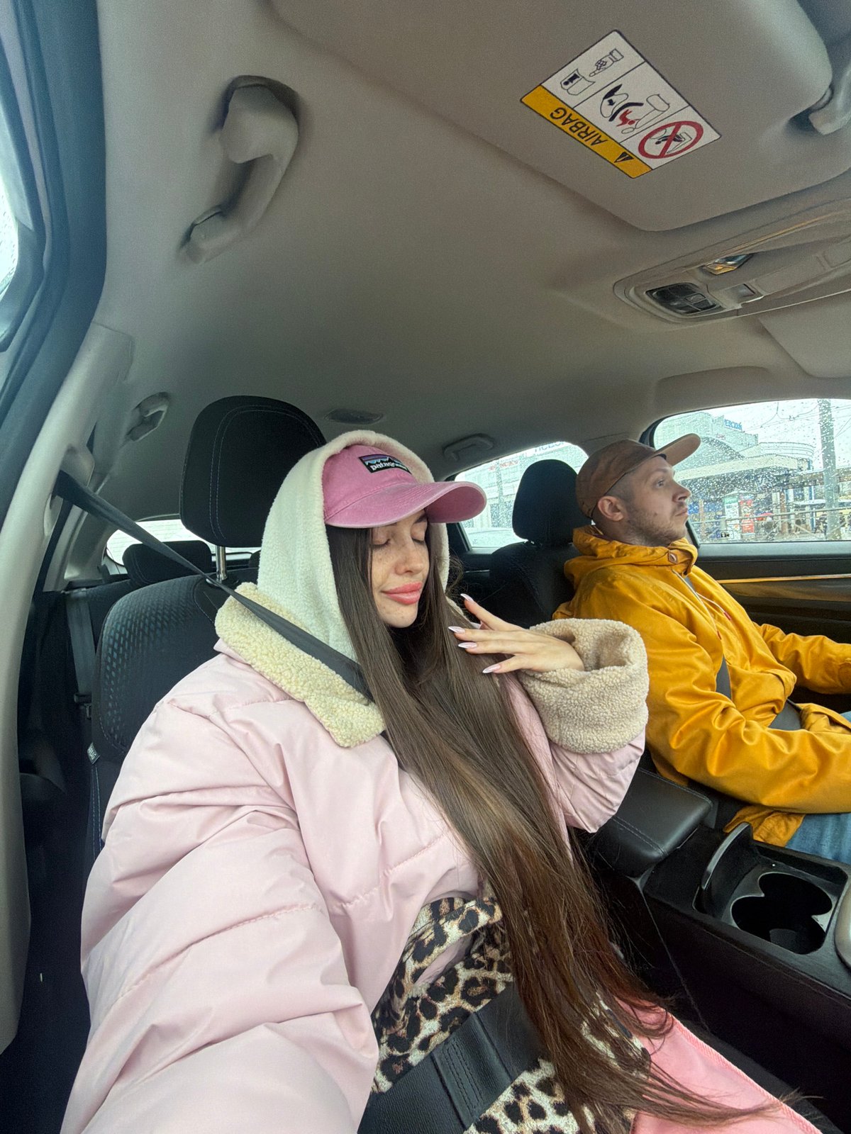Three people travel by car in Saint Petersburg