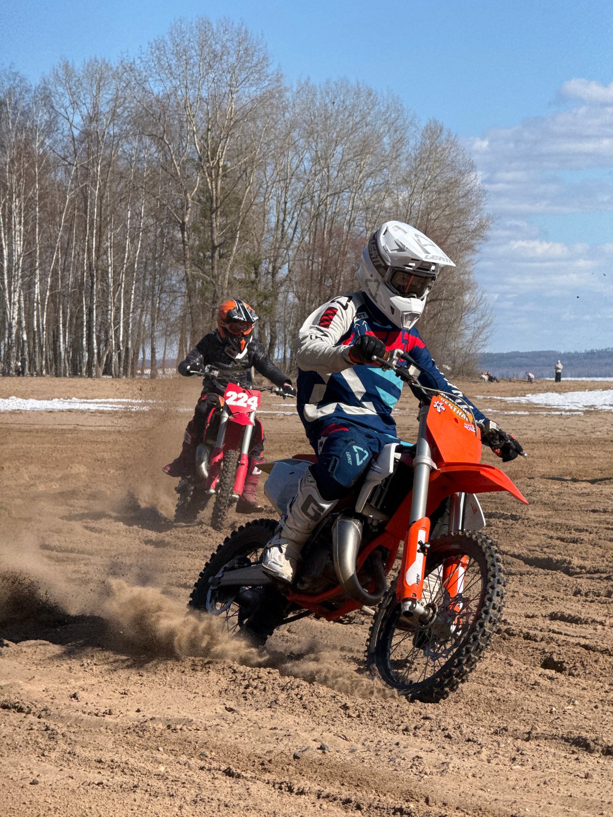 Motocross riders race on sandy tracks in Noviy, Russia