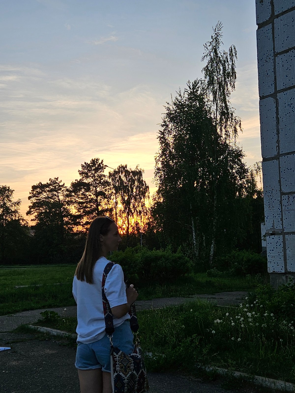 Woman enjoys spring flowers during sunset photoshoot in Chaikovsky