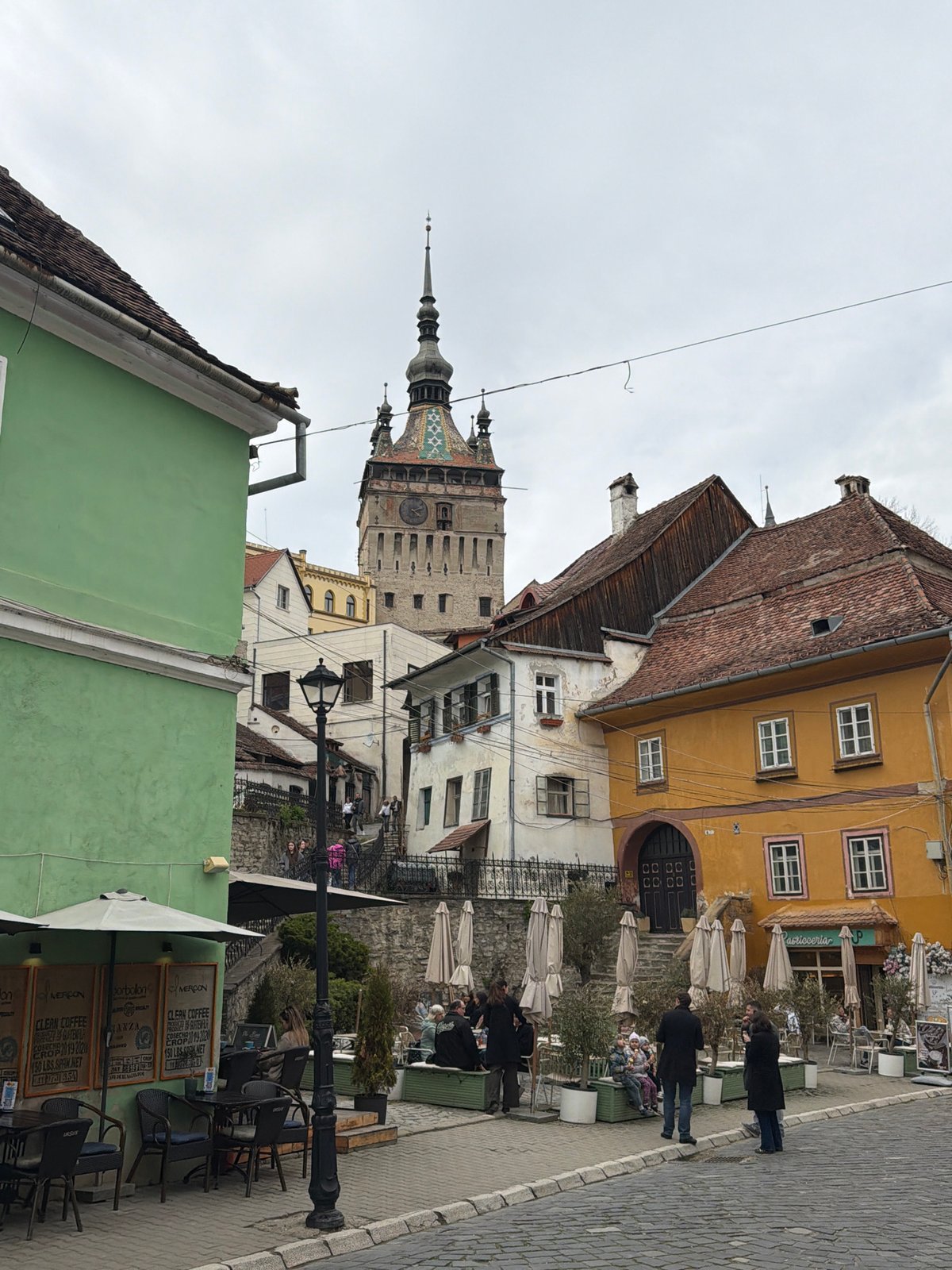 Tourist documents historic Sighișoara's medieval streets and landmarks