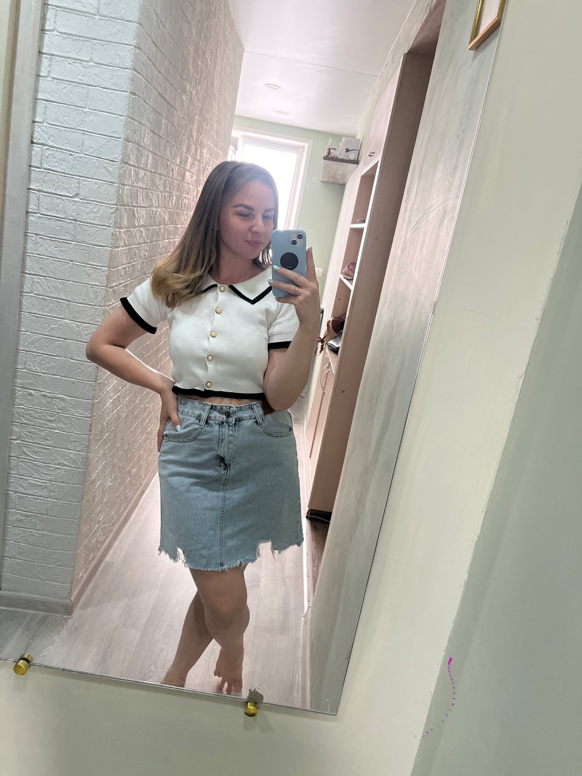 Woman takes selfies indoors in Izhevsk during early morning
