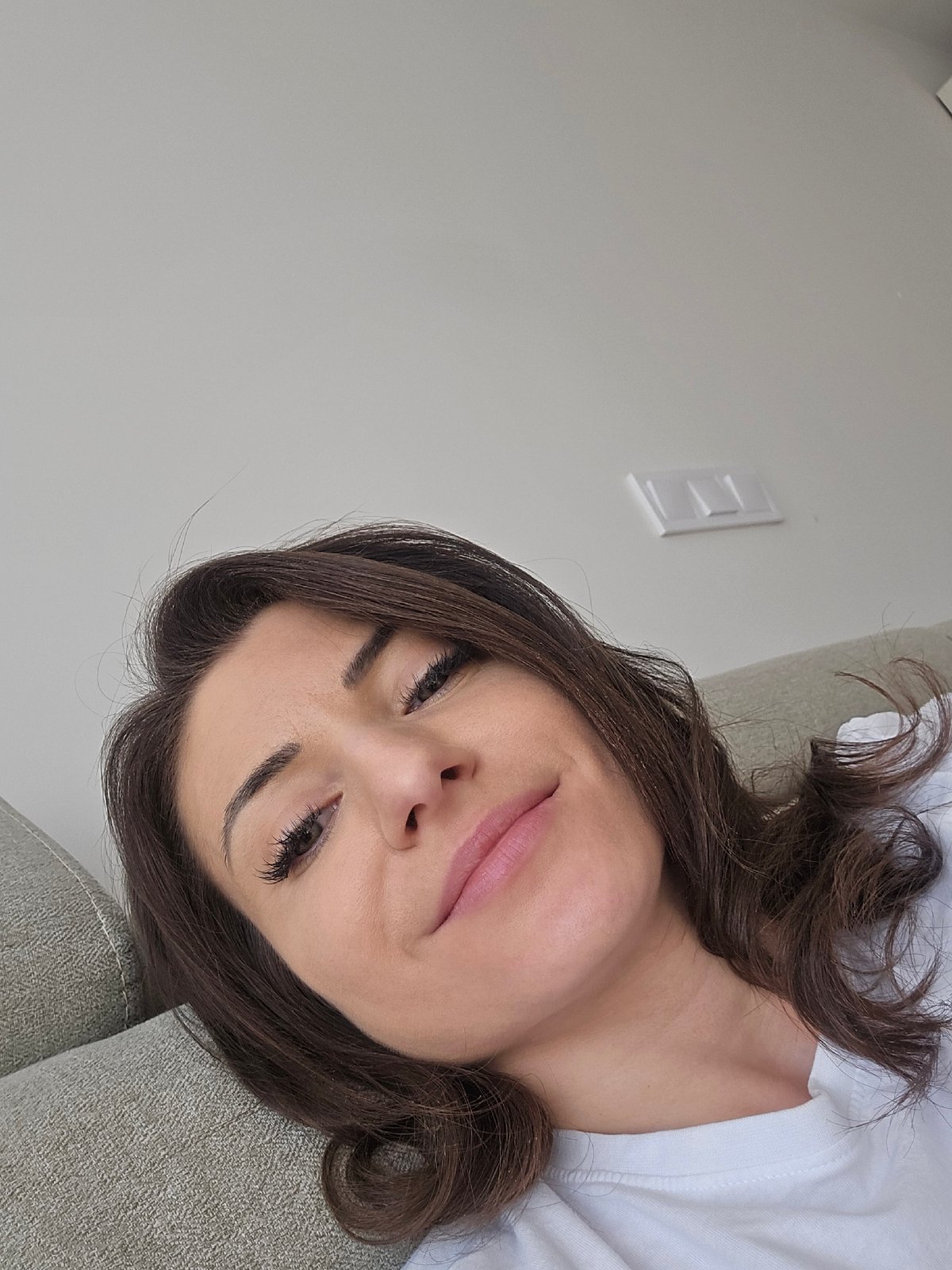 Woman takes selfie on couch in Sofia