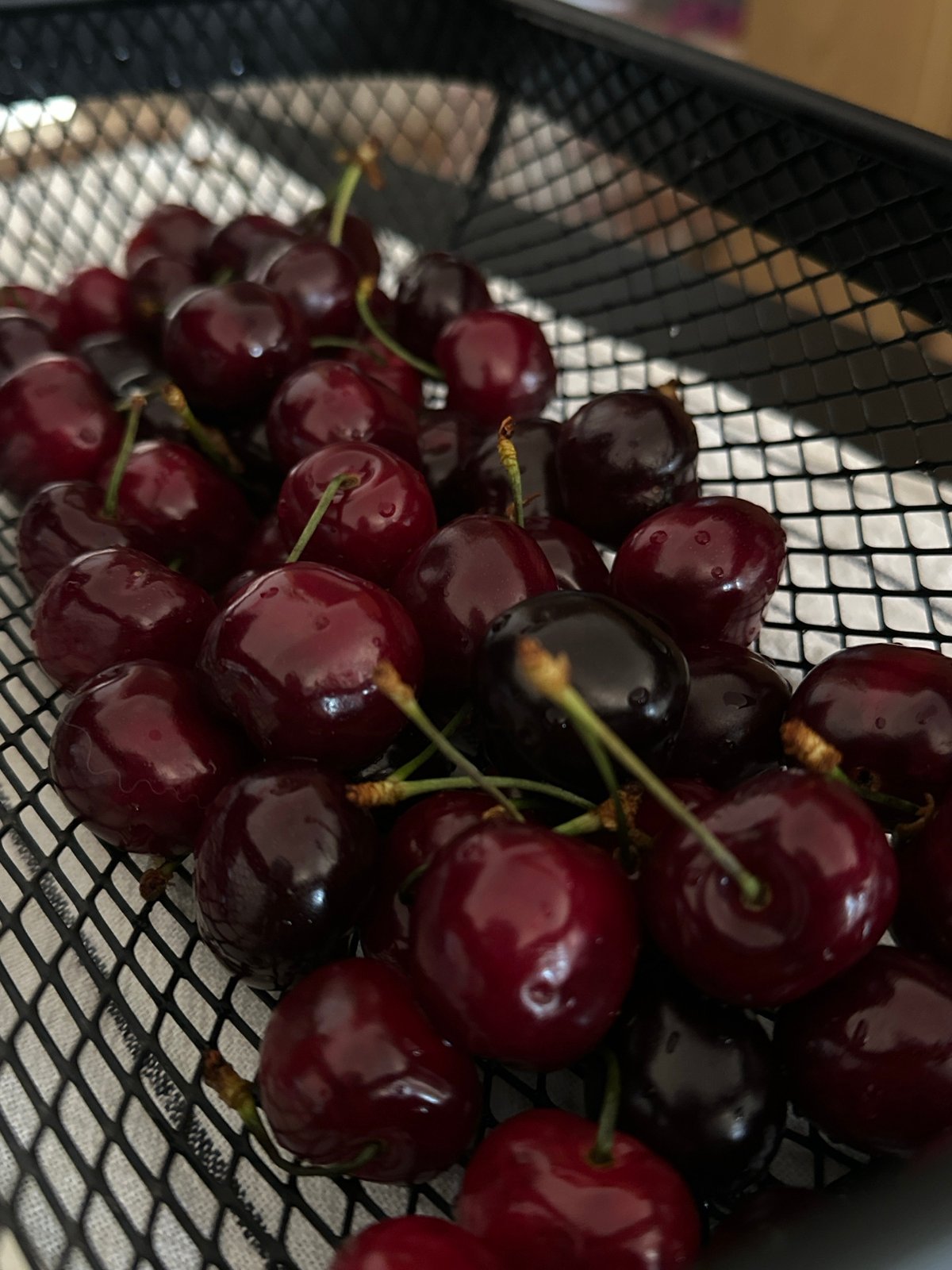 Fresh cherries displayed in wire basket in Montenegro