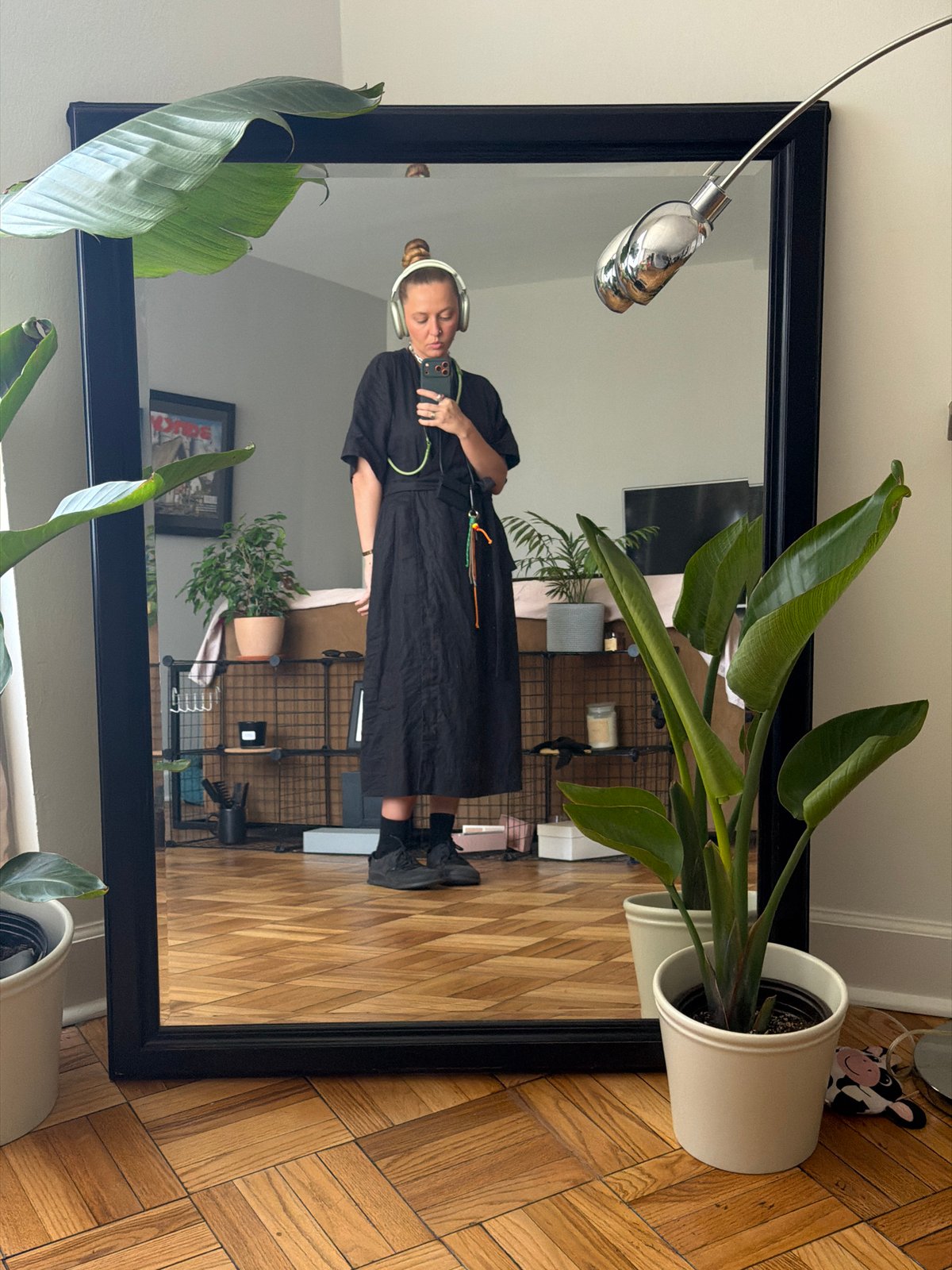 Person takes mirror selfie in black dress, Los Angeles
